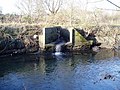 A surface water drain outflow into the River Brent on the right hand bank.