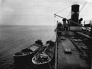 Several lighters beside a cargo ship's side somewhere off Java in the Dutch East Indies (present-day Indonesia), about 1925.