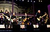 A band is performing at a stage in front of the White House