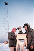 U.S. National Geodetic Survey technicians observing with a 0.2 arcsecond (≈ 0.001 mrad or 1 μrad) resolution Wild T3 theodolite mounted on an observing stand. Photo was taken during an Arctic field party (c. 1950).