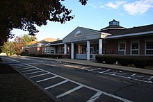 The front building facade of Harry Lee Cole School. The building is a red brick building.