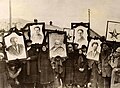 Image 23Russian peasants holding banners of Lenin (left), Marx (centre) and Trotsky (right) in early Soviet Russia. (from Russian Revolution)