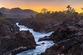 Li Phi falls at dusk with yellow sky in Don Khon Si Phan Don Laos