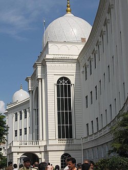 A white stone building with two domes