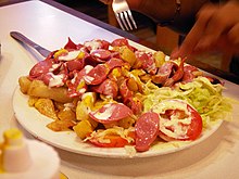 Salchipapas is a fast food dish commonly consumed as street food throughout Latin America. Lima salchipapas.jpg