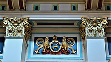 Two internal pillar tops and a relief of the city arms, featuring owls