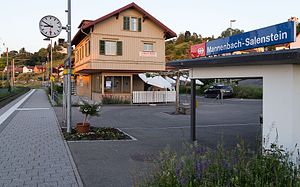 Platform shelter with three-story building in the background