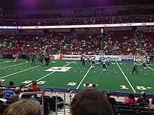 Players setting up on an arena football field