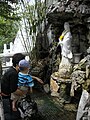 Small fountain with Guanyin dispensing water from her jar.