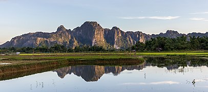 Water reflection of karst mountains at golden hour in Vang Vieng Laos