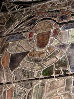 Thomas Becket window from Canterbury showing the pot metal and painted glass, lead H-sectioned cames, modern steel rods and copper wire attachments.