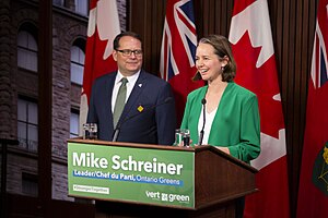 Aislinn Clancy and Mike Schreiner address the media from the Queen's Park Media Studio