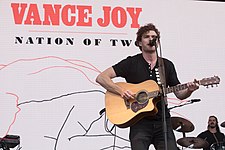 Joy performing in 2018 during the Nation of Two World Tour Vance Joy (40466599182).jpg