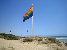 The rainbow flag flies in Capocotta, Ostia (Rome), a gay-friendly beach on the Italian Mediterranean Sea. Capocotta gay beach.jpg