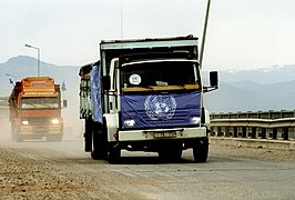 Trucks loaded with supplies drive across the border from Turkey into Iraq to take part in Operation Provide Comfort, a multinational effort to aid Kurdish refugees.