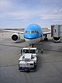 A KLM Boeing 777 being pushed back from a gate at Narita International Airport