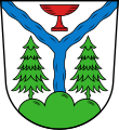 Gemeinde Warmensteinach In Silber über grünem Dreiberg zwischen zwei grünen Nadelbäumen eine blaue Wellendeichsel, die oben eine rote Glasschale einschließt.[3]