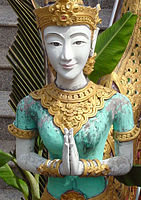 Statue with Namaste pose in a Thai temple