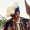 A man in cavalier costume on horseback