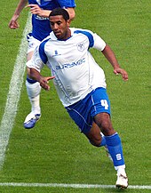 Black man playing football.