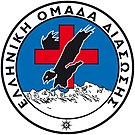 The Hellenic Rescue Team crest, a black eagle in front of a red cross, over white mountains.