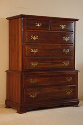 A highboy full of drawer pulls, backed by eschutcheon plates ChestOfDrawers.jpg