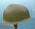 A side view of a Mid-century M1 helmet