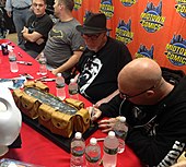 Artist Greg Capullo signs a replica Batman utility belt during an appearance at Midtown Comics in Manhattan. Beside him from left to right are Batman writers Scott Snyder, Tom King, and Frank Miller. 9.17.16BatmanDayByLuigiNovi49.jpg