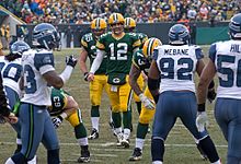 Packers and Seahawks players lined up before a snap.