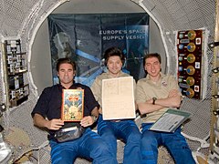 Crew in ATV with Jules Verne manuscript (cropped).jpg