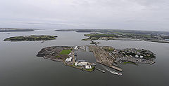 Aerial view with Naval Base to west (right), former industrial site to east (left) & dockyard (centre)