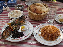 Grilled fish with a side of sayadiya rice Samak mashwi.jpg