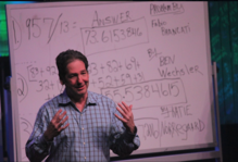 Mike Byster standing in front of a whiteboard during a TEDx presentation in Naperville, IL.