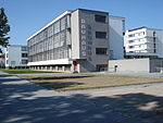 A grey modernist building with words Bauhaus on the facade