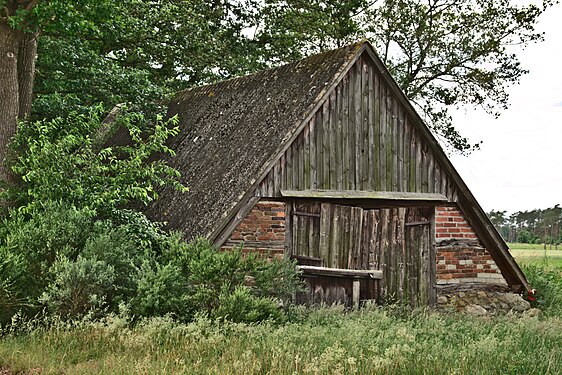 Old sheep pen with overgrown roof in Bissel, Germany.