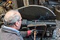 Demonstrating the shear hammer by cutting a segment of red hot cast iron bar which had previously been flattened by the tilt hammer