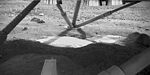 View underneath lander towards south foot pad, showing patchy exposures of a bright surface, possibly ice.[88]