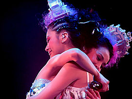 Twins hug each other at The Missing Piece Concert in 2006