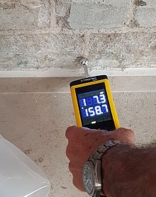 Measuring water leakage in exterior wall with Trotec T660 Moisture Measuring Device, using dielectric measurement method (indicative). MoistureMeter1.jpg