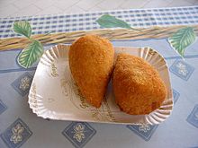 Arancini from Ragusa, Sicily. Arancini are fried or (less often) baked rice balls usually filled with ragu (meat sauce), tomato sauce, mozzarella or peas, and then coated in bread crumbs. Arancini.jpg