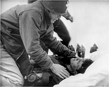 Joseph T. O'Callahan gives last rites to an injured crewman aboard Franklin on 19 March 1945