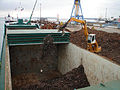 Loading scrap iron in to a cargo hold with sliding covers