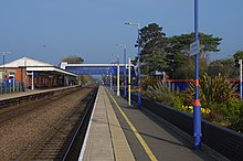 Bicester North railway station showing buildings, platform, and gardens