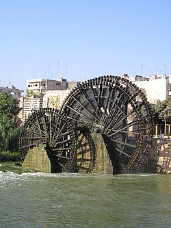 Three wheels of different sizes in a river