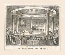 Engraving of interior view of the Broadway Tabernacle in New York City circa 1850. Black ink printed on a yellowed page shows a round room with a tall coffered dome ceiling supported by 6 corinthian columns and a simple chandelier suspended from the middle of the ceiling. About 2,500 people are seated, and some standing, to watch a speaker on the stage in the middle standing in front of a pipe organ. The view is surrounded by a lightly decorative frame.