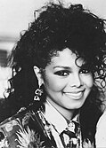 Janet Jackson smiling towards the camera.