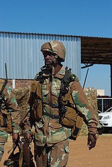 South African paratrooper wearing the SA M83 version of the OR-201 helmet at the Roodewal Weapons Range, 9 May 2013. Roodewal Weapons Range - (8725870376).jpg