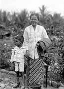 Portrait of a woman in sarong and kebaya with child