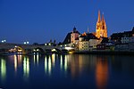 City panorama at night with a bridge over a river and a church