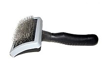 A slicker brush with wire bristles, used for removing loose hair from the coat. Dog brush.JPG